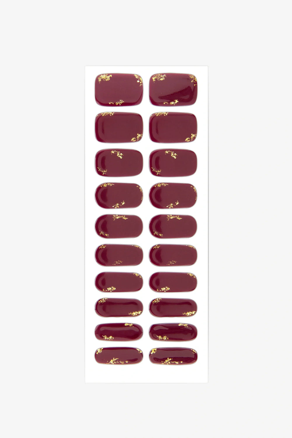 Sheet of semi-cured gel nail wraps in rich maroon with gold leaf detailing and a glossy surface.