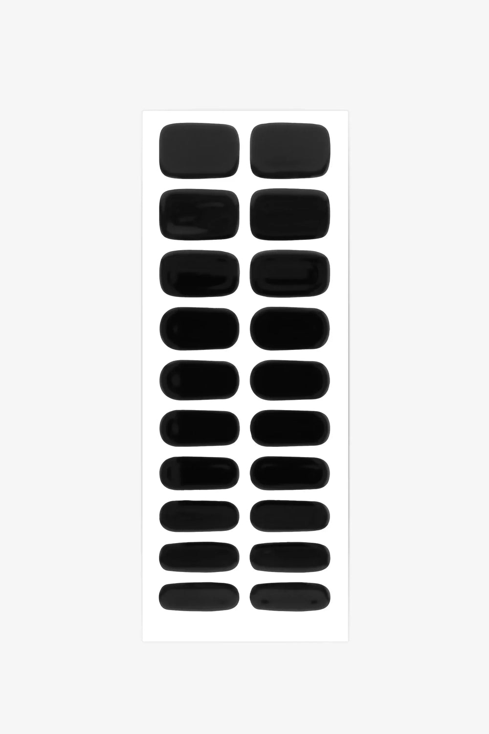 Sheet of matte black semi-cured gel nail strips with solid opaque color and smooth texture