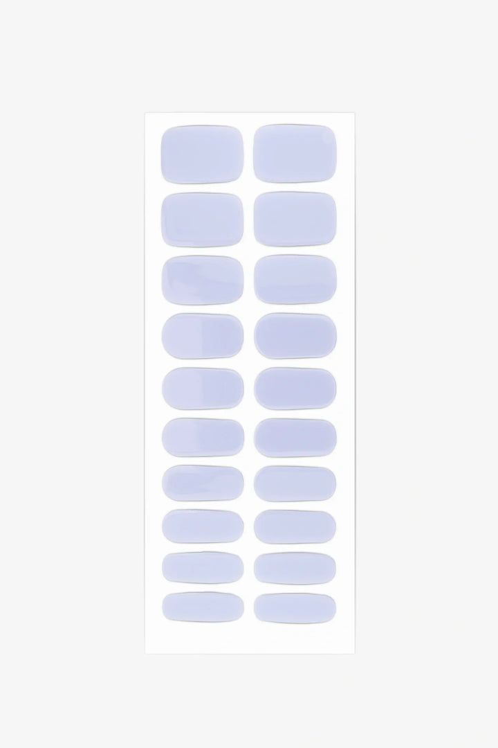 Sheet of semi-cured gel nail wraps in pale lavender-blue tones with a polished glossy surface.