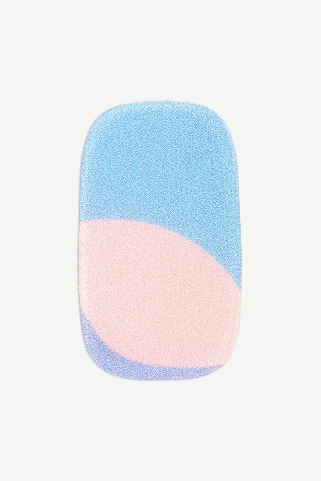 Close-up of a pastel rainbow stick-on gel nails with pink and blue gradient on a nude, sheer background.