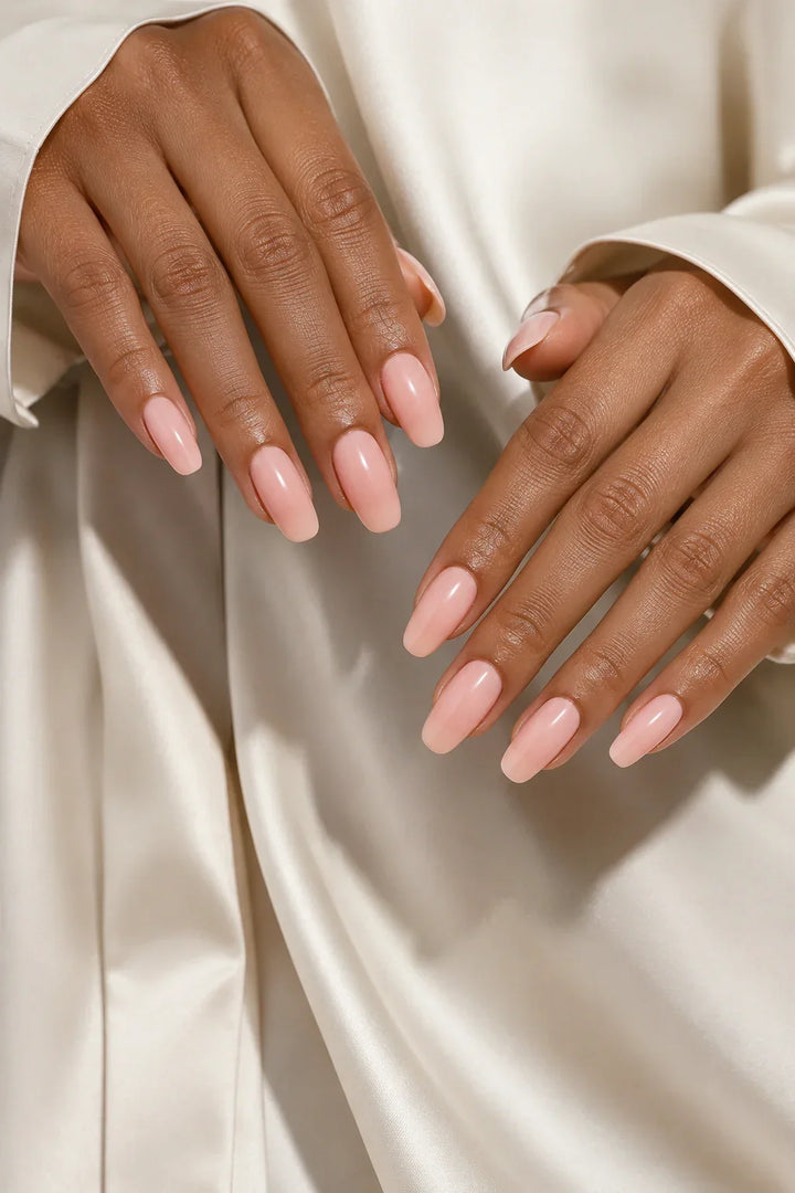 Peach Glaze UV-free gel nail wraps in a very light pastel peach with a soft milky finish and a glossy shine, shown on medium skin.