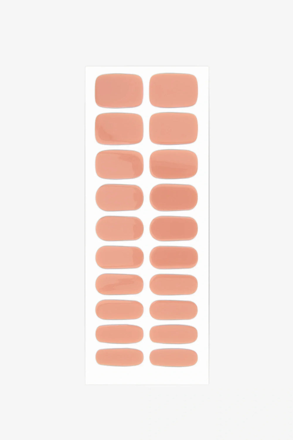 Sheet of semi-cured gel nail wraps in soft peach tones with a creamy, high-gloss surface.