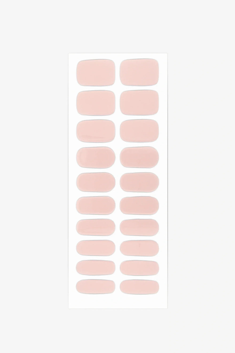 Sheet of semi-cured gel nail wraps in muted nude-pink tones with a smooth, velvety matte texture.
