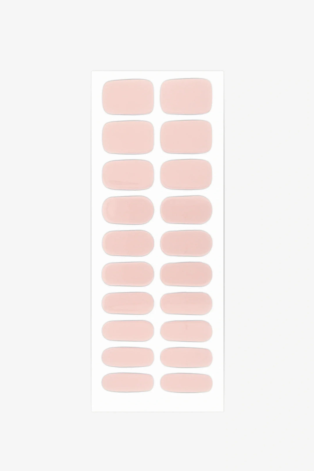 Sheet of semi-cured gel nail wraps in muted nude-pink tones with a smooth, velvety matte texture.