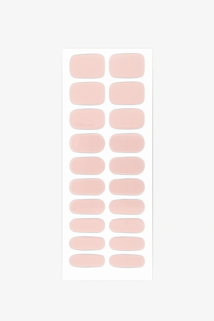 Sheet of semi-cured gel nail wraps in muted nude-pink tones with a smooth, velvety matte texture.