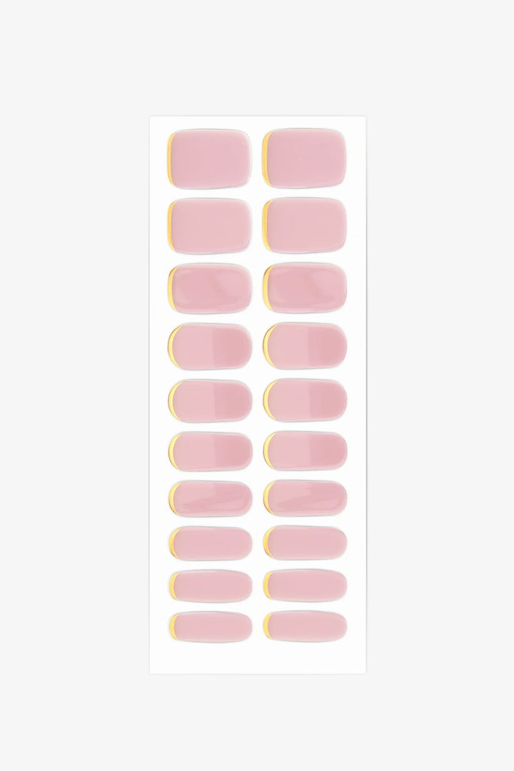 Full sheet of Pink Moon gel nail wraps in nude-pink tones with gold cuff accents, displayed in various sizes on a white background.