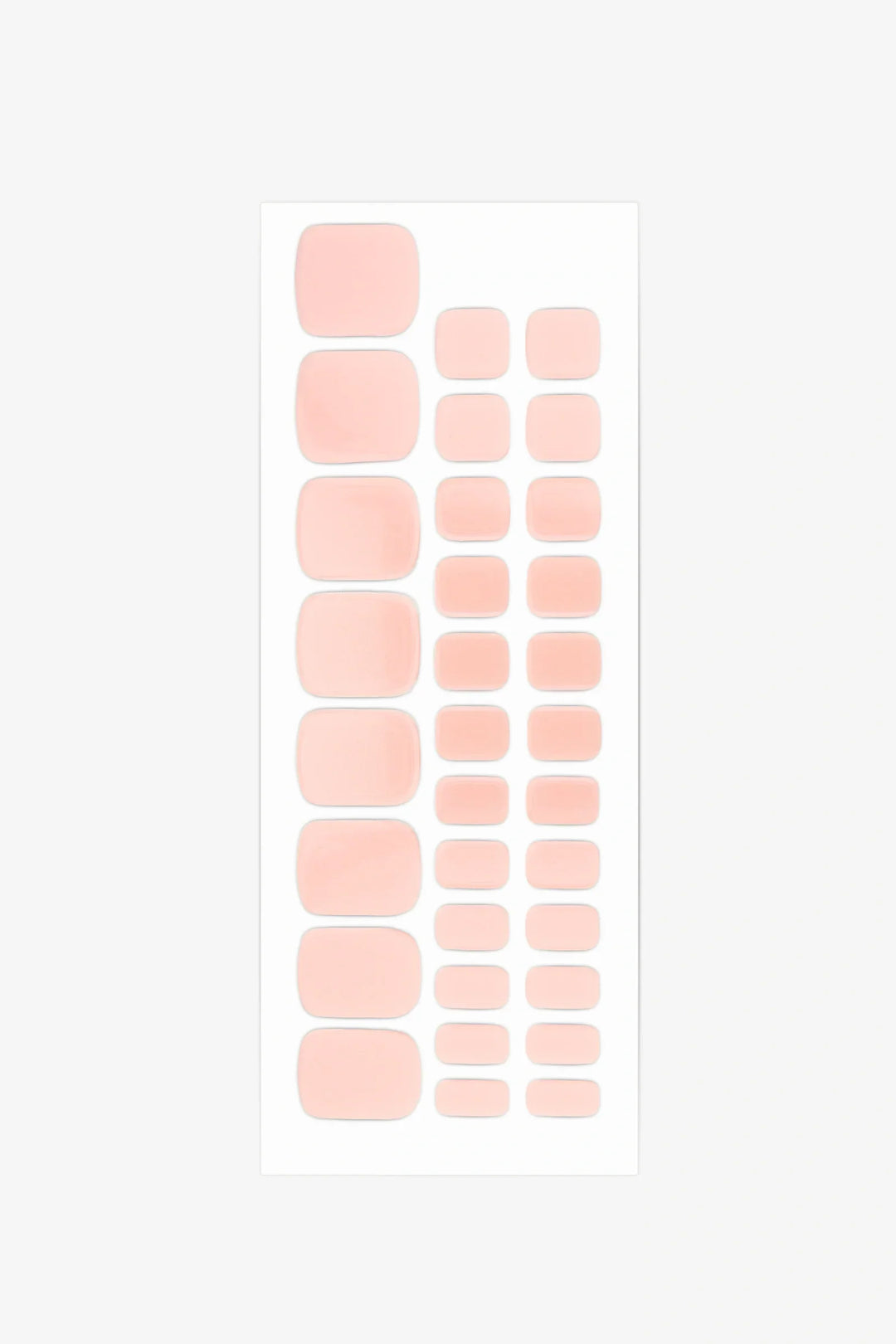 Full sheet of blush pink gel toenail strips in varying sizes displayed on a white background.