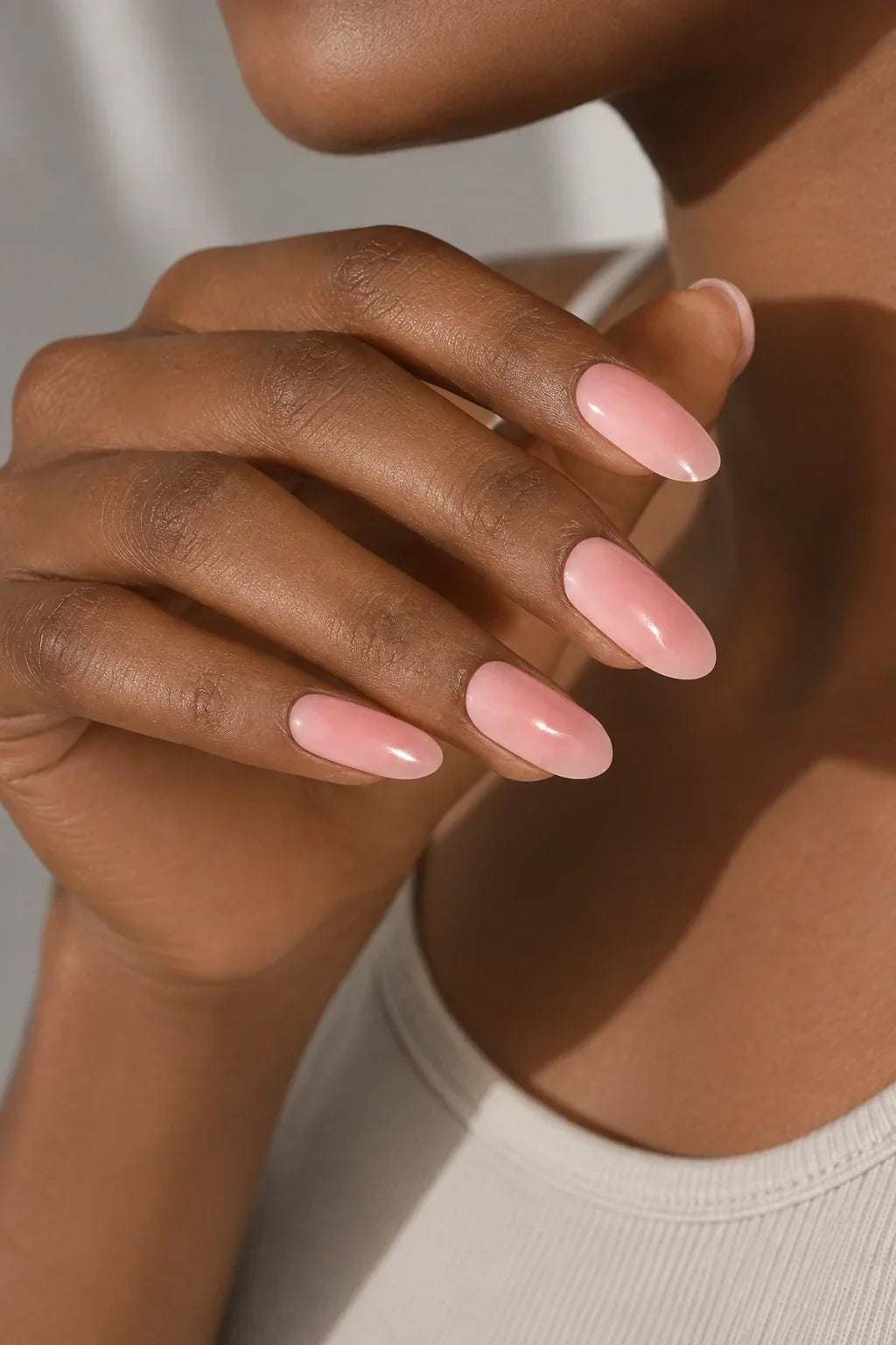 Pink Rose UV-free gel nail wraps in a soft blush pink gradient that transitions from a deeper blush pink to a light milky pink, with a glossy finish, shown on dark skin