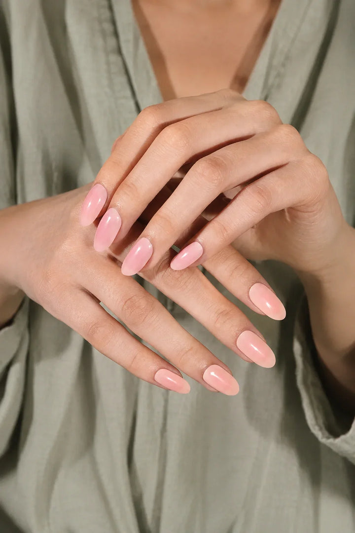 Pink Rose UV-free gel nail wraps in a soft blush pink gradient that transitions from deeper rosy pink to a light milky blush nude, with a glossy finish, shown on light skin.