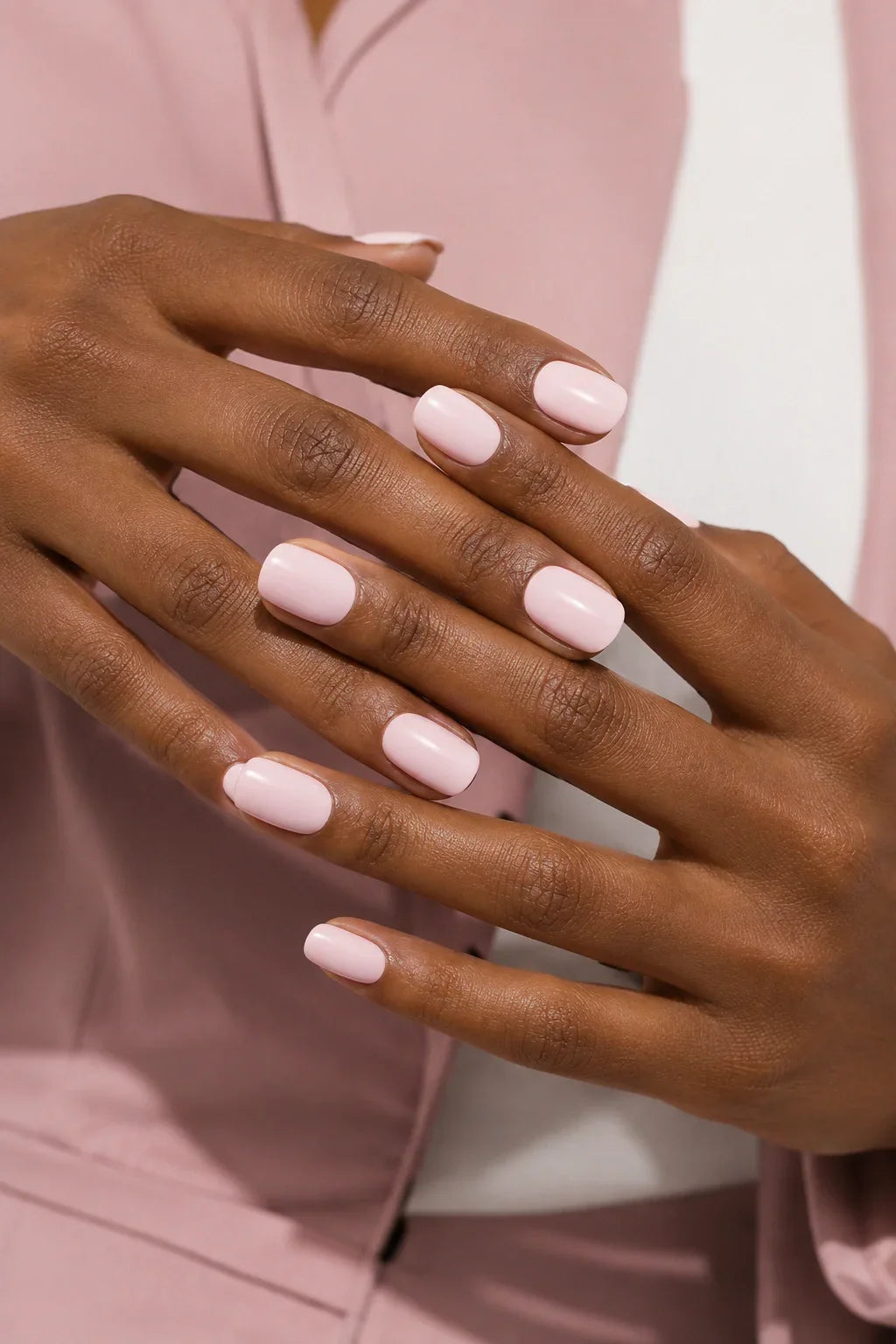 Powder Pink UV-free gel nail wraps in a soft pastel pink with a smooth glossy finish, shown on dark skin.