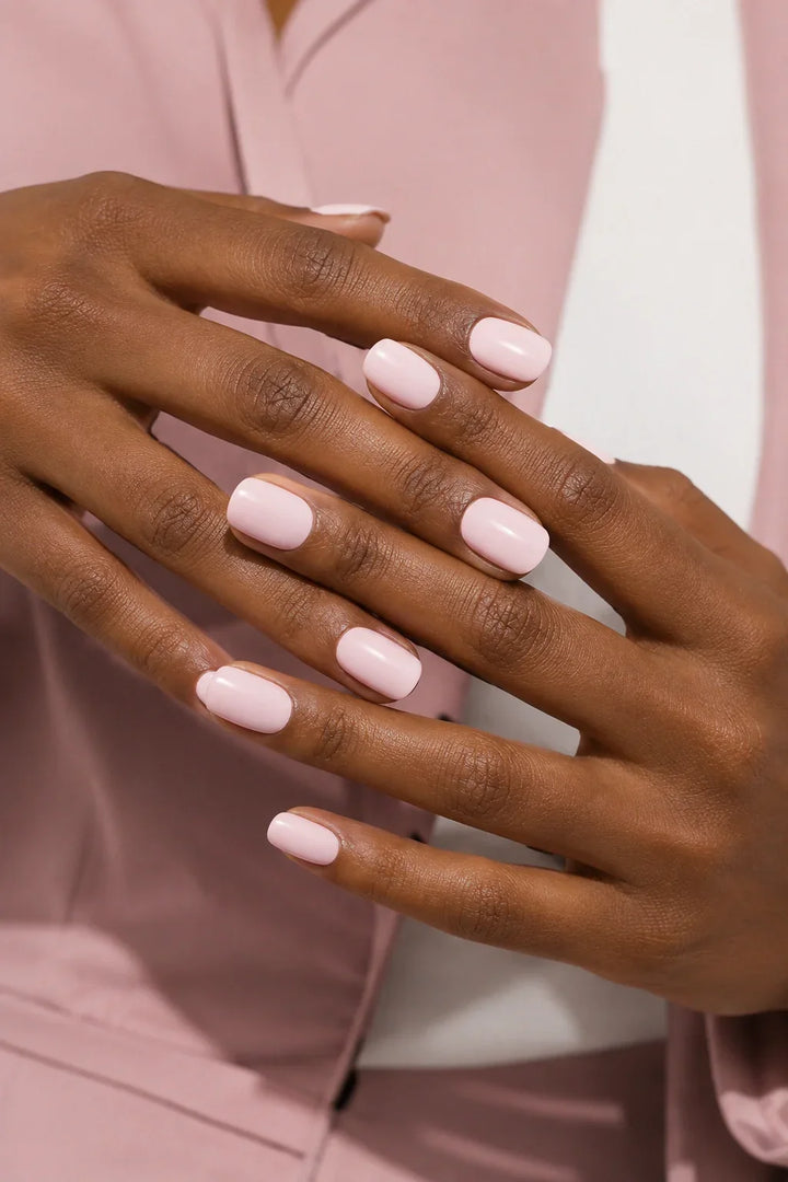 Powder Pink UV-free gel nail wraps in a soft pastel pink with a smooth glossy finish, shown on dark skin.