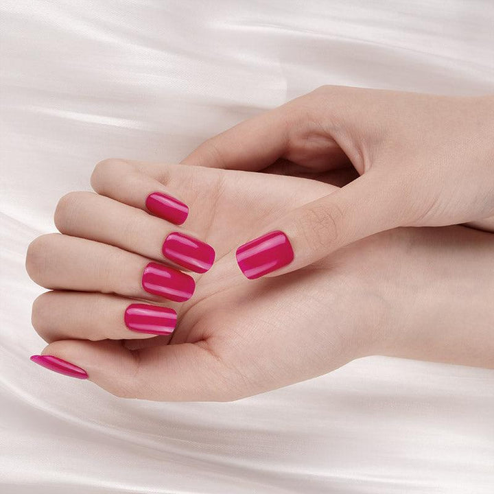 Rich mauve gel nail wraps with glossy finish on light skin tone, photographed against soft satin fabric.