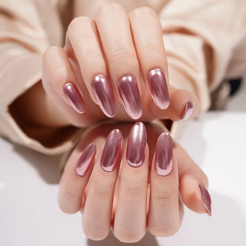 Rose Quartz semi-cured gel nail stickers in a rosy metallic pink, photographed under bright diffused studio lighting on light skin with a beige blouse in the background.