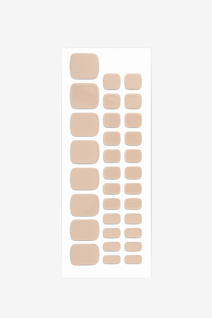 Full sheet of Sandstone Beige semi-cured gel toenail stickers displaying various sizes on a white background.
