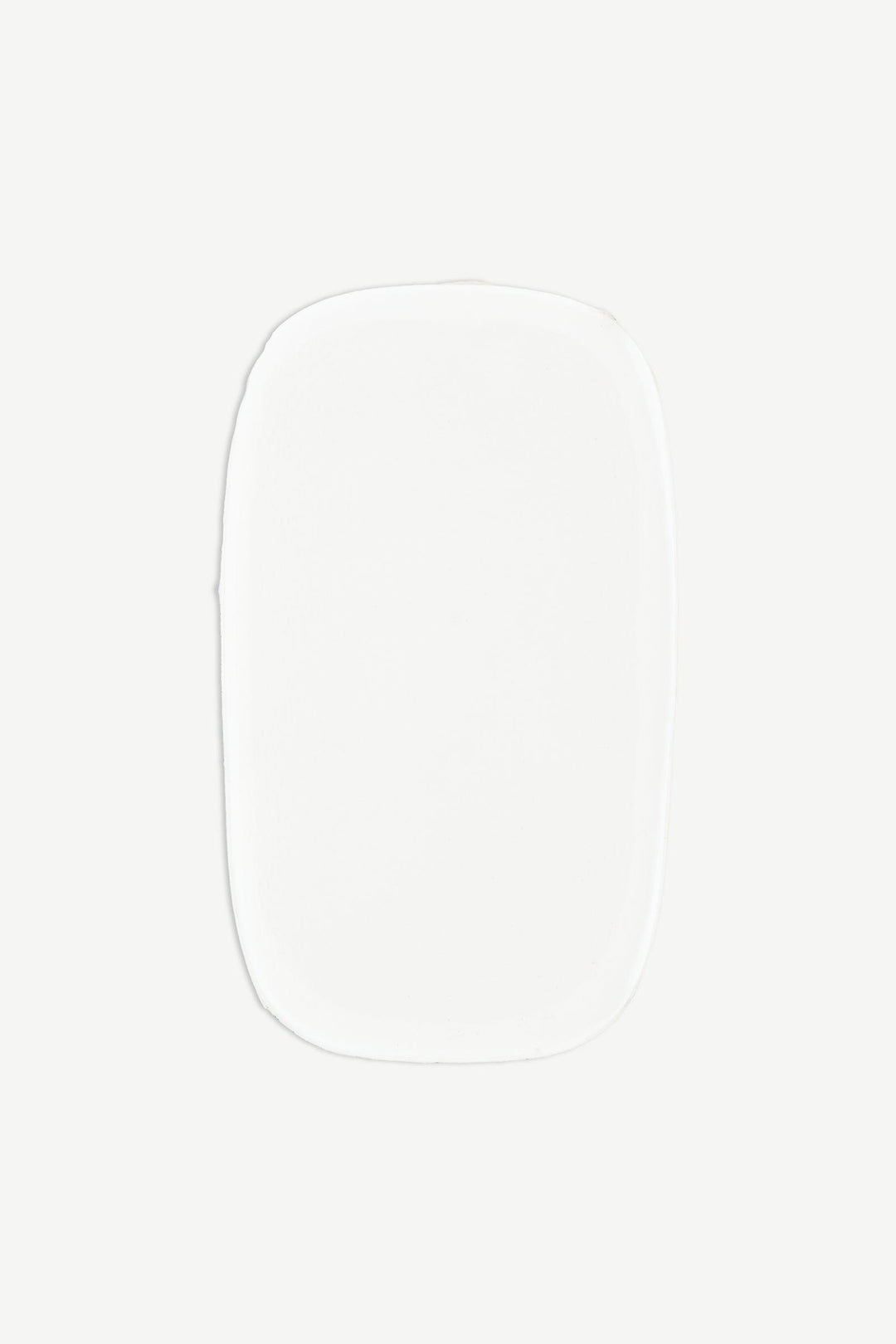 Macro image of a single strip of sheer nude semi-cured gel nail wraps showing subtle ombré fade and high-gloss surface.
