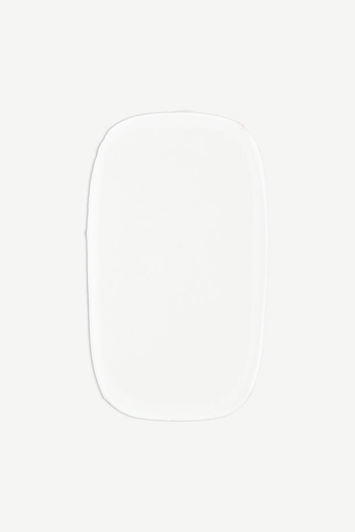 Macro image of a single strip of sheer nude semi-cured gel nail wraps showing subtle ombré fade and high-gloss surface.
