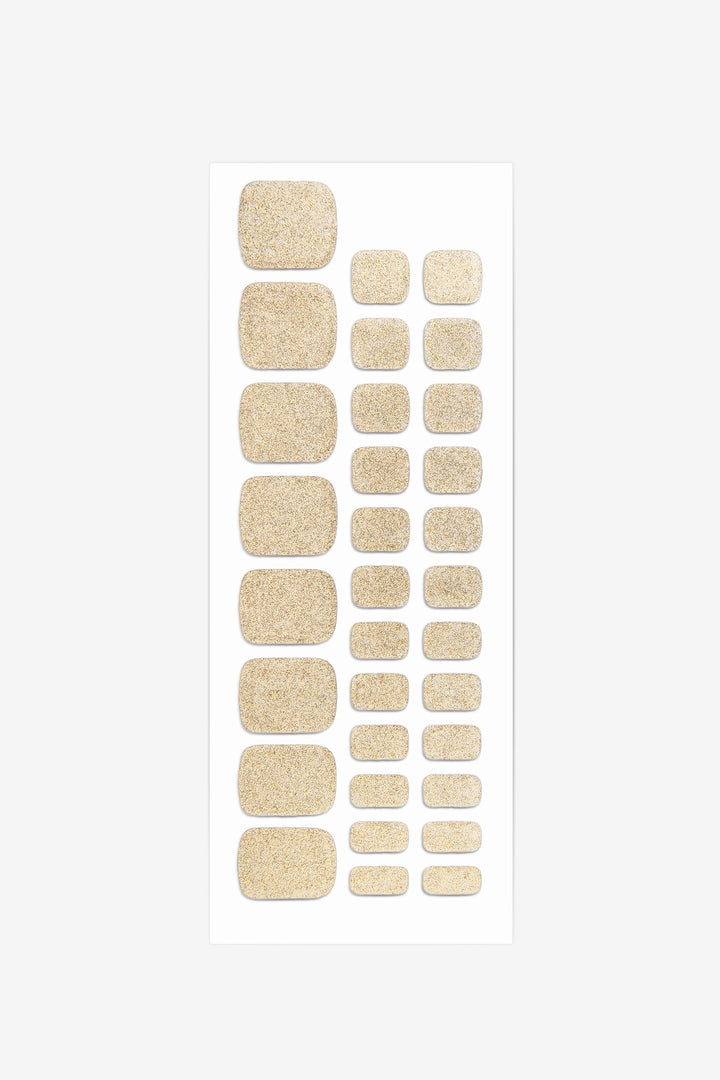 Full sheet of Shimmering Gold semi-cured gel toenail stickers displaying various sizes on a white background.