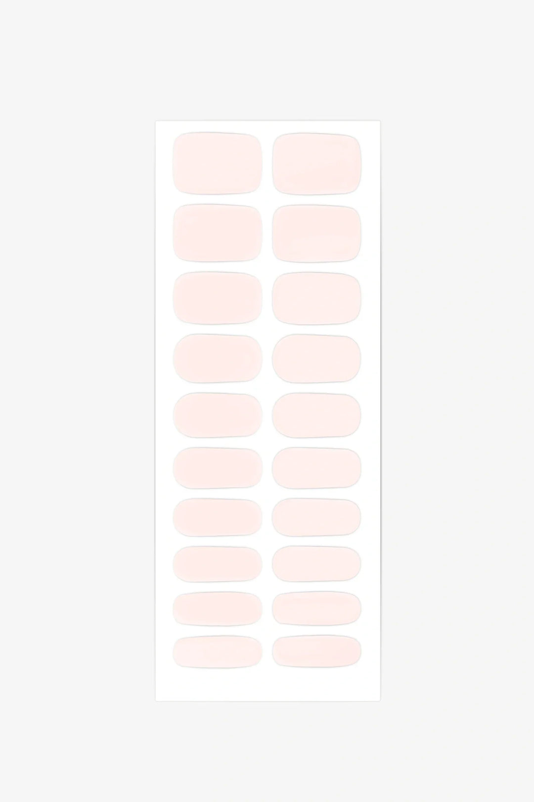 Sheet of semi-cured gel nail wraps in soft pink, with 20 rounded rectangular strips in varying sizes arranged on a white backing