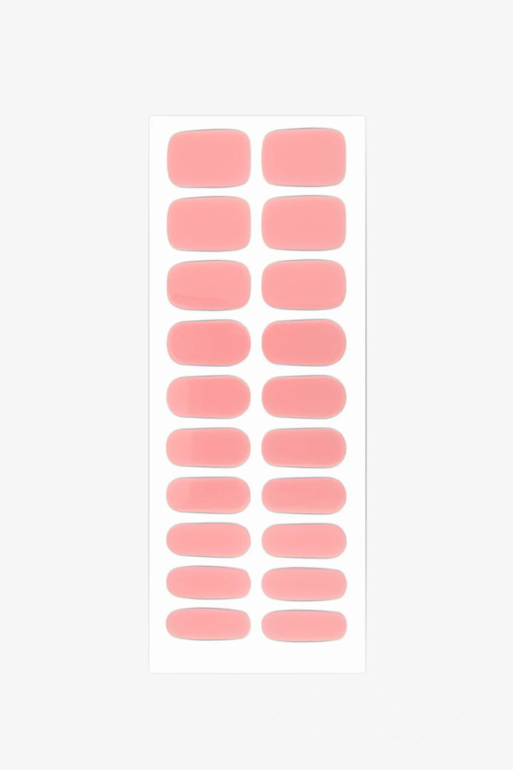 Sheet of semi-cured gel nail wraps in milky pastel pink shades with a glossy, translucent surface.