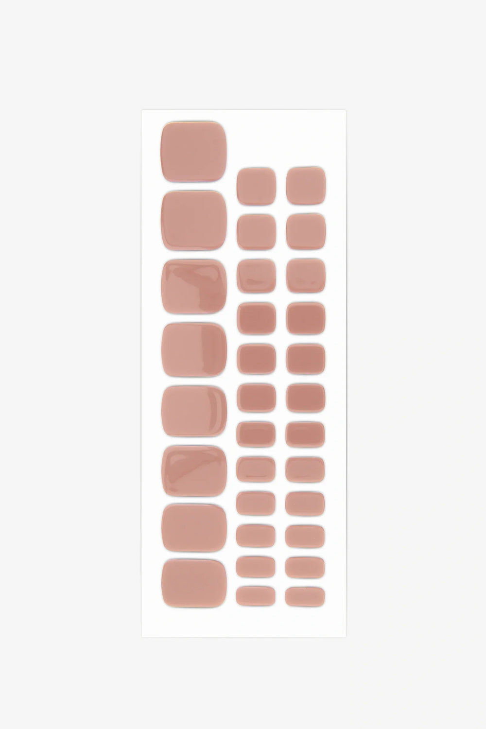 Full sheet of taupe gel toenail strips arranged in various sizes on a white background.