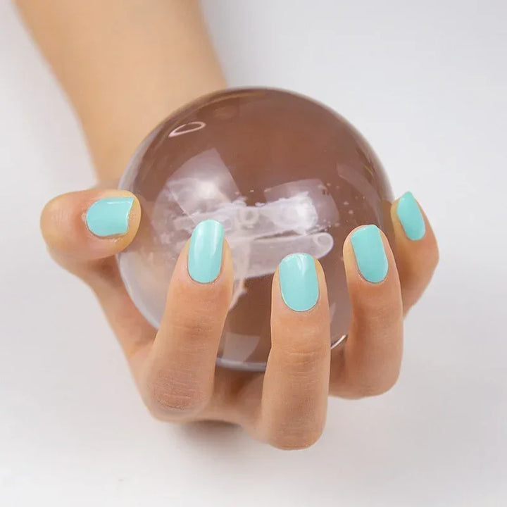 Semi-cured gel nail wraps in light turquoise aqua with a crisp, high-gloss finish, shown on medium skin tone with neatly rounded nails.