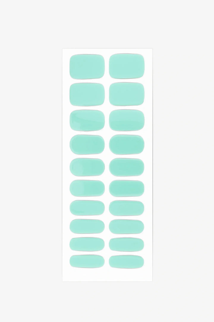 Sheet of semi-cured gel nail wraps in bright turquoise aqua tones with a smooth, glossy surface.